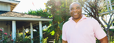 A picture of a man smiling, happy with his choice of housing as a retiree.